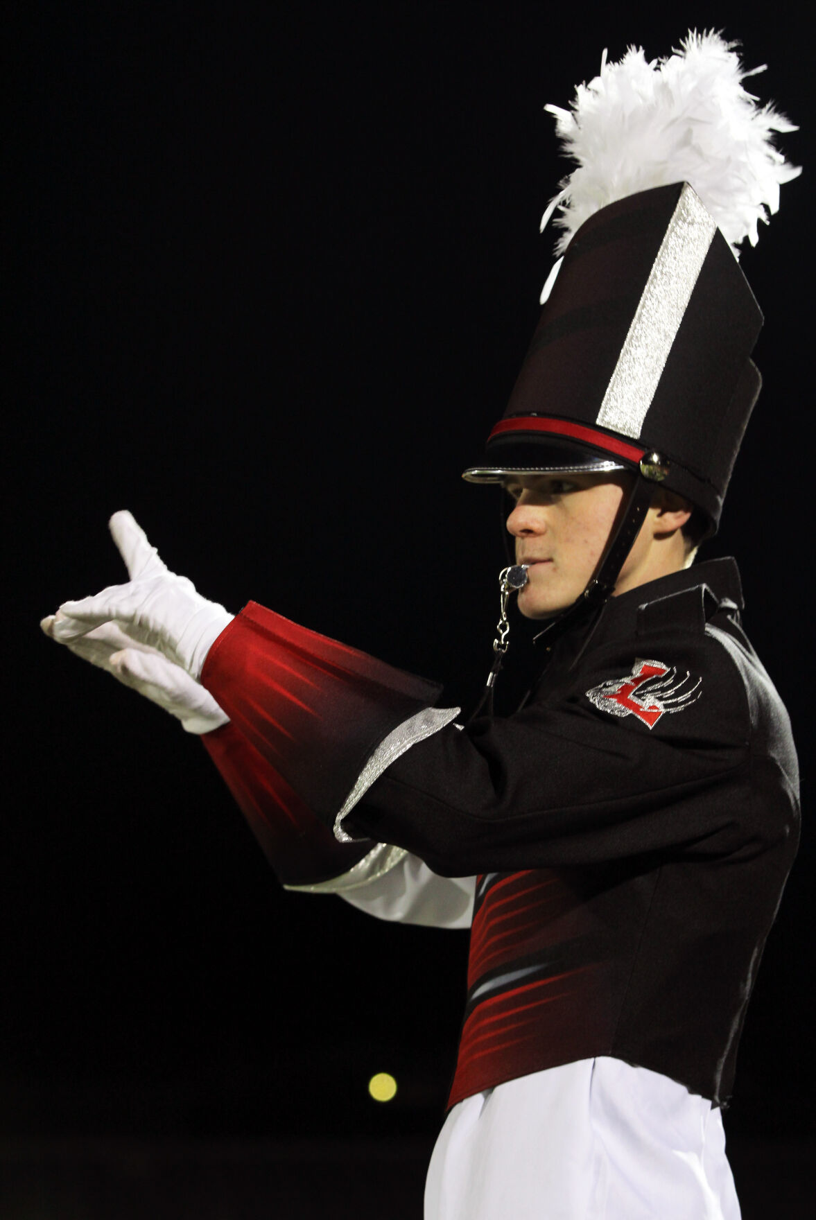 Lamar High School junior Jacob Morrison conducts the school's marching band